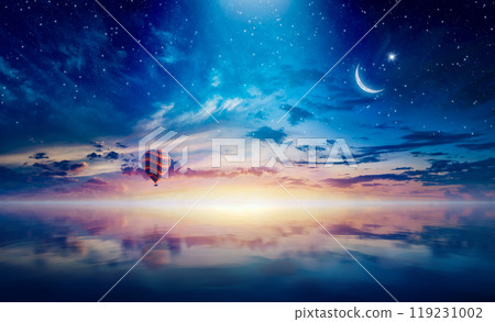 Crescent and hot air balloon rising above serene sea in sunset glowing sky Crescent and hot air balloon rising above serene sea in sunset glowing sky 119231002