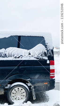 snow on the car glass in the form of mountains 119232046