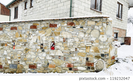 stone fence with decor in winter 119232047