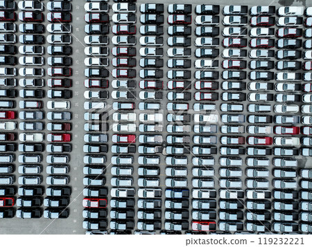 Aerial view vehicle assembly plant parking lot packed with cars, pickup truck, and SUV. Logistics, transportation strategy, electric and hybrid vehicle production. Trade agreements and tariffs. 119232221
