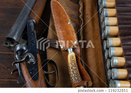 double barreled side shotgun with cartridges in bandolier. double barreled side shotgun with cartridges in bandolier. 119232851