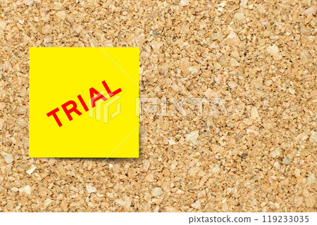 Yellow note paper with word trial on cork board background with copy space 119233035