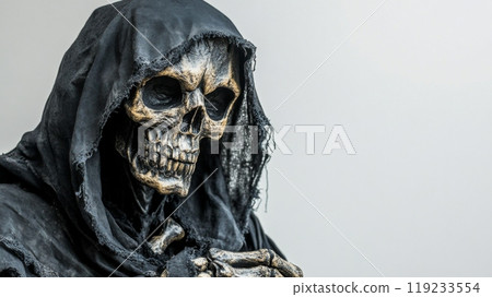 Skeleton grim reaper wearing black hood posing for camera 119233554