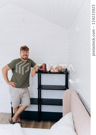 Father and son spending time together in a cozy, modern home interior with minimalist design Father and son spending time together in a cozy, modern home interior with minimalist design 119233925