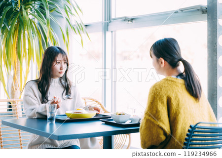 A woman dining at a restaurant 119234966