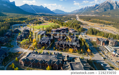 Aerial view of Town of Canmore residential area in a autumn sunny day. Canadian Rockies mountain range in the background. Alberta, Canada. 119235650