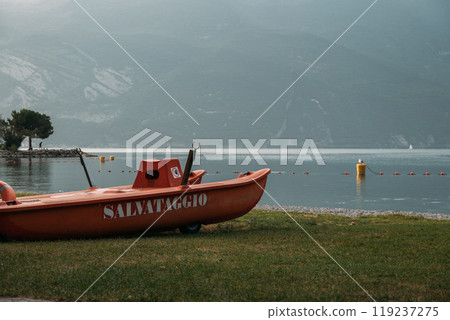 A beautiful rescue boat is docked at a stunning lake in the picturesque Dolomites, inviting exploration and adventure 119237275