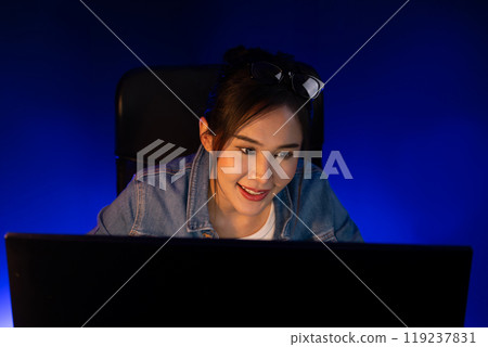 Smiling beautiful asian creative looking pc in sales target online. Stratagem. Smiling beautiful asian creative looking pc in sales target online. Stratagem. 119237831