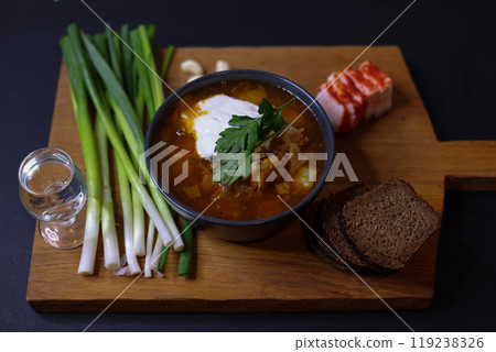 Indulge in a bowl of Delicious Homemade Soup crafted from Fresh Ingredients served with Bread 119238326