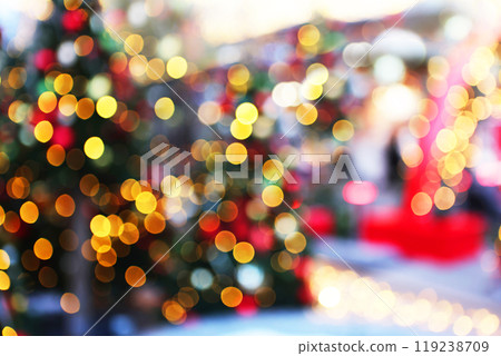 The garland with lights on the Christmas tree is out of focus. Christmas texture for postcards. A place to advertise. Background for congratulations. 119238709