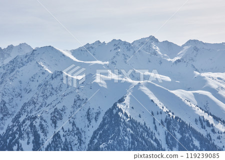 Winter in Kyrgyzstan mountains. Mountain range, snow capped peaks 119239085