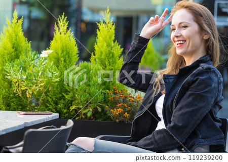 Woman waiting in outdoor restaurant cafe. Woman waiting in outdoor restaurant cafe. 119239200