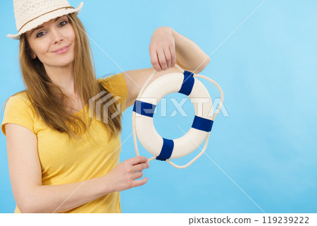 Girl holds life buoy rescue ring Girl holds life buoy rescue ring 119239222