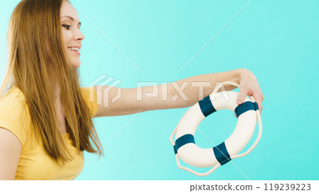 Girl holds life buoy rescue ring 119239223