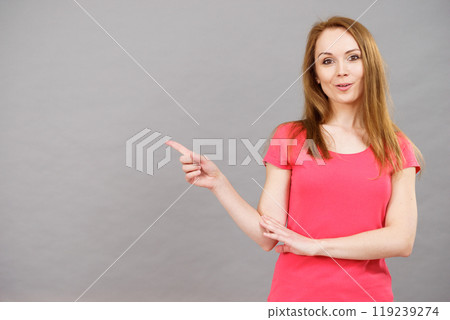 Woman pointing, surprised face expression 119239274