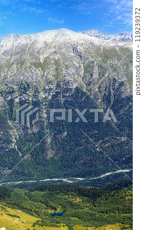 View of a small river with a waterfall flowing 119239372