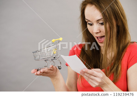 Woman with shopping list and cart 119239476