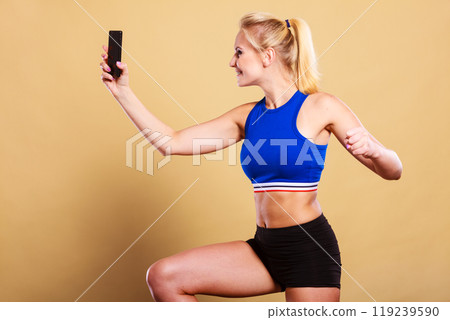 Fit woman taking selfie picture with phone 119239590