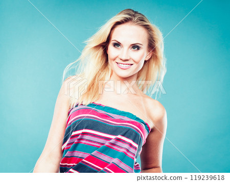 Blonde woman wearing colorful striped strapless shirt Blonde woman wearing colorful striped strapless shirt 119239618