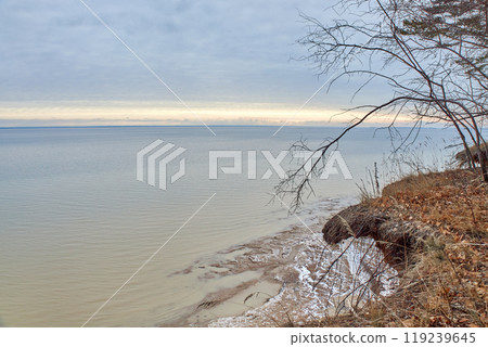 Sunset on sea with blue clouds and streak of bright yellow sunlight. Novosibirsk reservoir, Ob Sea, artificial pond Sunset on sea with blue clouds and streak of bright yellow sunlight. Novosibirsk reservoir, Ob Sea, artificial pond 119239645
