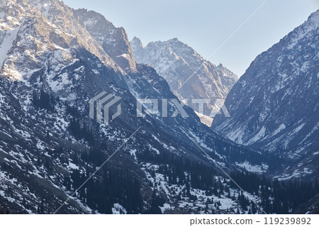 Mountain valley in early spring. Slightly snow-covered rocky Mountains slopes 119239892