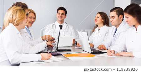 Doctors in negotiations in conference room Doctors in negotiations in conference room 119239920
