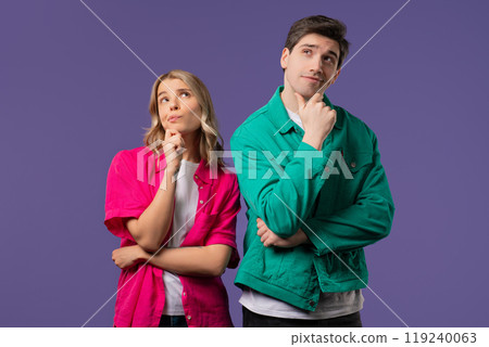 Curious young couple analyzing on violet studio. Mindful man woman searching solution, finding answer. Memory concept 119240063