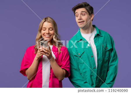 Suspicious man Spying On girlfriend Chats With Smartphone. Jealousy, Curiosity Suspicious man Spying On girlfriend Chats With Smartphone. Jealousy, Curiosity 119240090