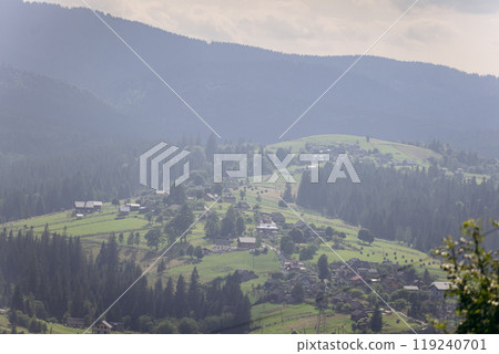 Stunning panoramic view of Vorokhta village nestled in the Carpathian Mountains, with green hills Stunning panoramic view of Vorokhta village nestled in the Carpathian Mountains, with green hills 119240701