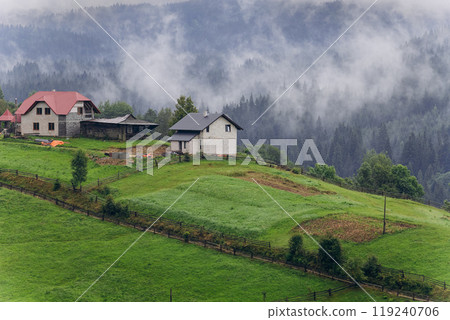 Misty morning in Vorokhta village with scenic view of Carpathian hills and fog-covered mountains Misty morning in Vorokhta village with scenic view of Carpathian hills and fog-covered mountains 119240706