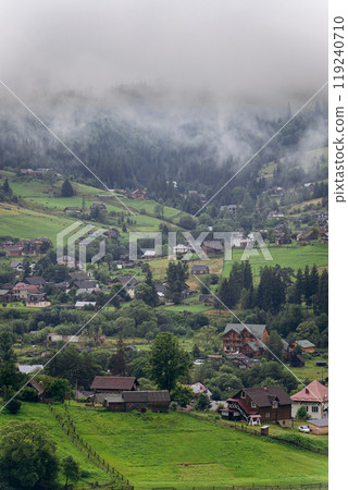 Misty morning in Vorokhta village with scenic view of Carpathian hills and fog-covered mountains Misty morning in Vorokhta village with scenic view of Carpathian hills and fog-covered mountains 119240710