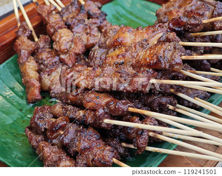 Grilled meat on skewers on a charcoal grill 119241501