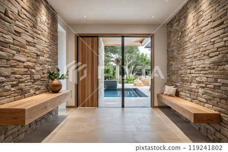A large open space with a stone wall and a pool in the backgroun 119241802