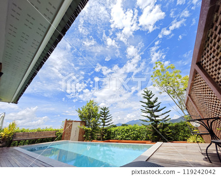 A swimming pool with sunlight reflecting on a clear sky A swimming pool with sunlight reflecting on a clear sky 119242042