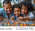 A candid shot of a family playing board games at home 119242792