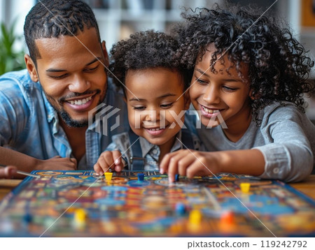 A candid shot of a family playing board games at home 119242792