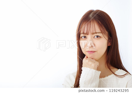 A young woman thinking with a troubled look 119243295