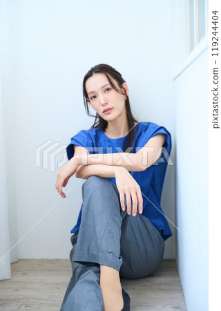 A woman sitting on the floor A woman sitting on the floor 119244404