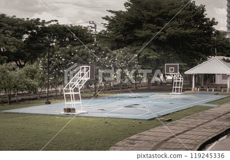 Basketball backboard with the hoop metal ring at basketball court in the park. 119245336