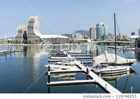 View of Yacht Marina at Glory Pier of Kaohsiung Port, Taiwan. with the Kaohsiung Music Center building. View of Yacht Marina at Glory Pier of Kaohsiung Port, Taiwan. with the Kaohsiung Music Center building. 119246855