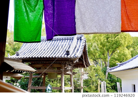 View of the grounds of Mizuma Temple (Mizuma Kannon) with the bell tower visible through the five-colored curtain, Mizuma, Kaizuka City, Osaka Prefecture 119246920