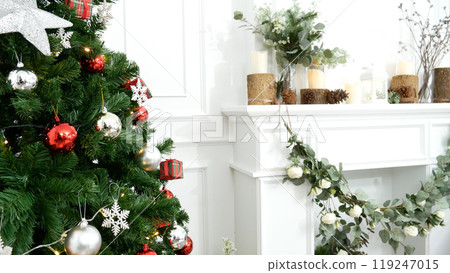 Blurred Background Christmas tree decorated holiday winter xmas celebration. Present gift decorate under bauble ornament silver red ball on christmas tree in cozy living room. Blurry background 119247015
