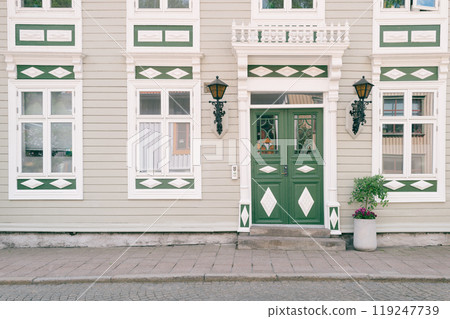 Beautifully decorated green door and window 119247739