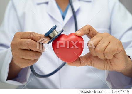Doctor holding a red heart in hospital ward, healthy strong medical. Doctor holding a red heart in hospital ward, healthy strong medical. 119247749