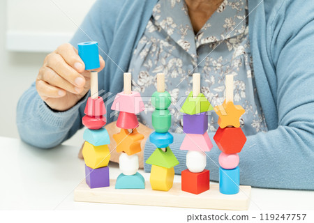 Alzheimer disease AD, Asian elderly woman patient suffering from dementia learn practical motor skills rehabilitation. 119247757