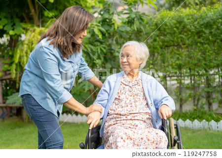 Caregiver help and care Asian senior woman patient sitting on wheelchair at nursing hospital ward, healthy strong medical. 119247758