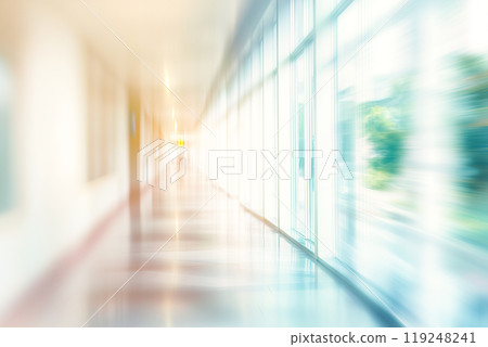 A hospital corridor where soft sunlight fills the space 119248241