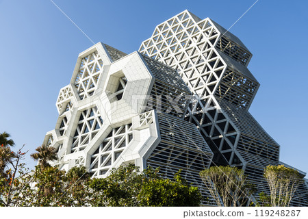 Low angle view of Kaohsiung Music Center in Taiwan. The white hexagonal building structure on the shore of Kaohsiung Port. Low angle view of Kaohsiung Music Center in Taiwan. The white hexagonal building structure on the shore of Kaohsiung Port. 119248287