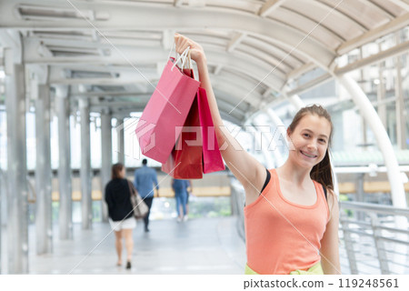 Shopaholic Women holding shopping bags ,money ,credit card person at shopping malls.Fashionable Woman love online website with sales tag on black Friday. E-commerce fashion digital marketing lifestyle 119248561