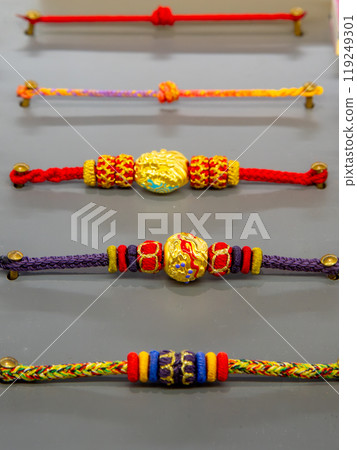 Colorful braided charm bracelets in display Colorful braided charm bracelets in display 119249301